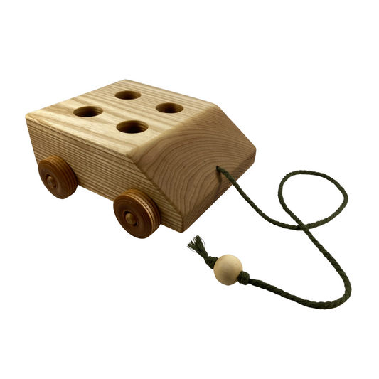 A wooden pull behind cart with four peg people, great for imaginative play.