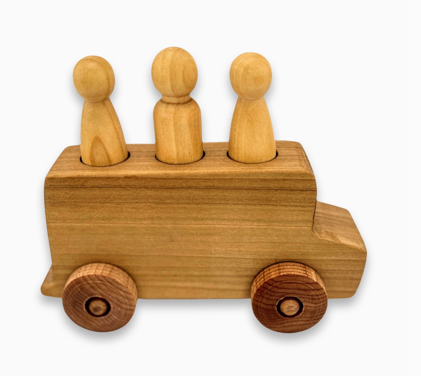 A wooden toy bus with three wooden figures sitting on top, resembling passengers.
