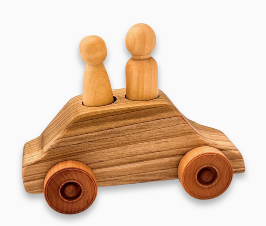 A wooden toy car with two peg people figures placed on top.